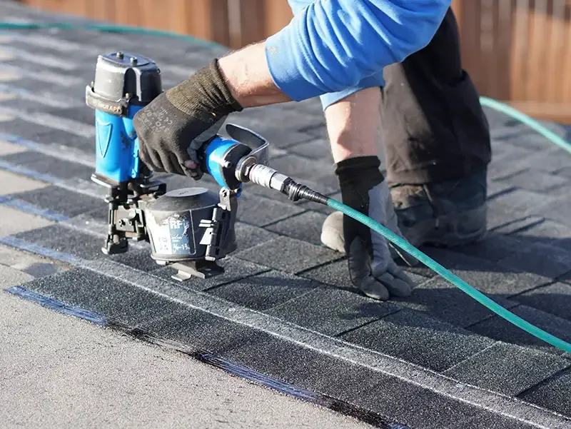 Dedicated Roofing team member working on a rooftop in Calgary.