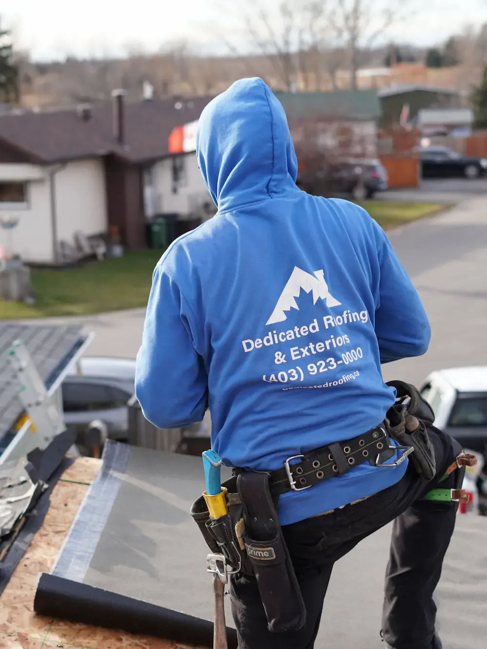 Dedicated Roofing team member working on a rooftop in Calgary.