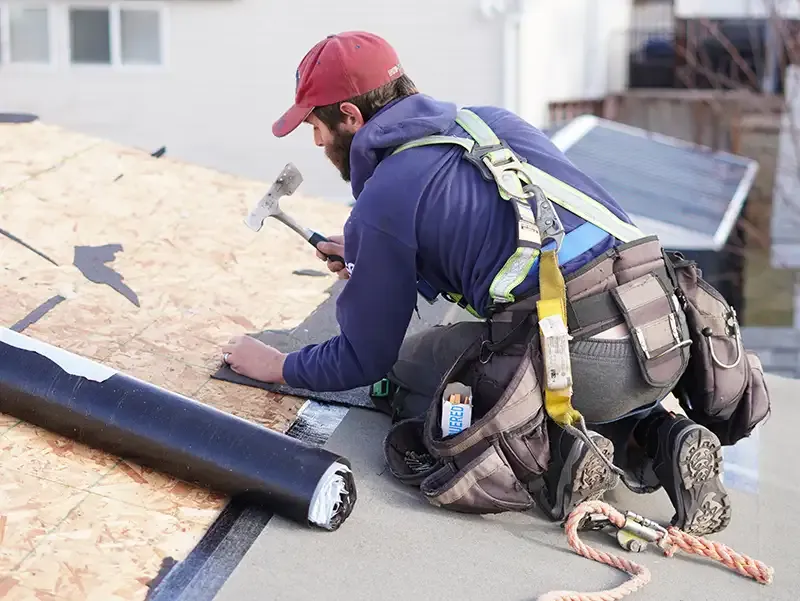 Dedicated Roofing team member working on a rooftop in Calgary.