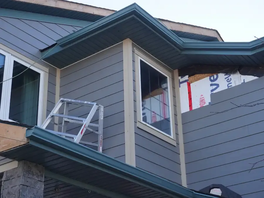 New siding being installed on an exterior wall.