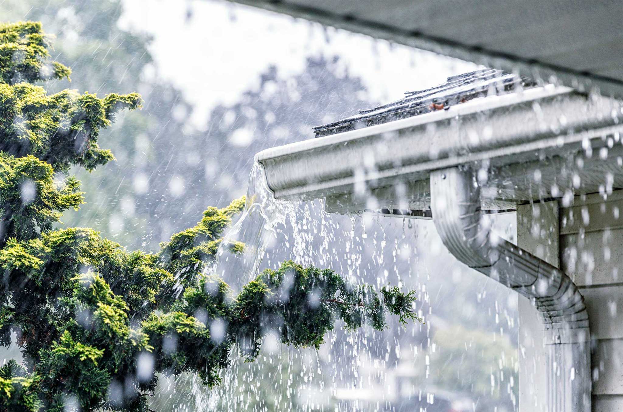 Rain on Gutters from a new Gutter Installation for your Calgary Roof Dedicated Roofing and Exteriors